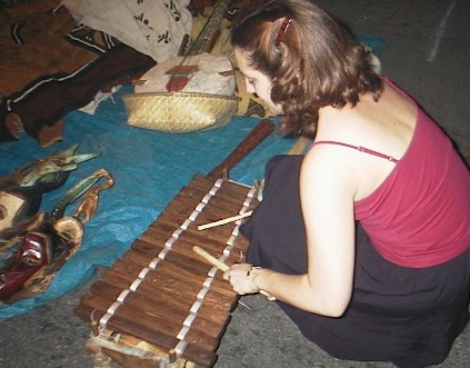 Valerie tests a marimba at the Roots and Heritage Festival (2002 Sep 6)