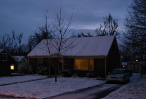 my snow-covered house at twilight