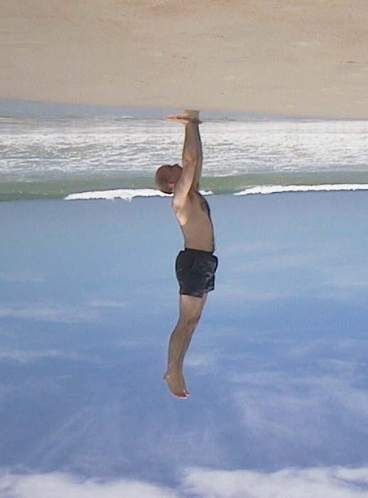Brett standing on the sky to touch the beach
